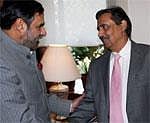 Union Minister of Commerce, Industry & Textiles Anand Sharma shakes hands with Pakistan Commerce Secretary Zafar Mehmood during a meeting in New Delhi on Tuesday. PTI