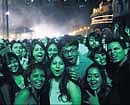 Bathed by the blue-green laser light, New Year revellers celebrate at the Palace Grounds in the City.   DH&#8200;photo/Kishor Kumar Bolar