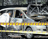 Indian security and forensic officials examine a car belonging to the Israel Embassy after an explosion tore through it, injuring four people in New Delhi on Monday. AP