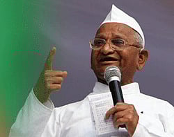 Anti-corruption activist Anna Hazare gestures as he addresses supporters during his day long fast against corruption at Jantar Mantar in New Delhi on Sunday. PTI