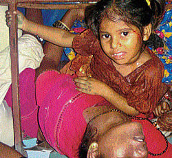 life and death: A&#8200;child hangs on to the railings inside the Hampi Express as a woman, her condition unknown, lies after the train accident at a station near Penukonda, in Andhra Pradesh on Tuesday. AP