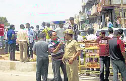 Bajrang Dal activists staging stir demanding arrest of the culprits who assaulted Dal Convener.(Below) Police security was beefed up at various places in Madikeri to avoid untoward incidents.