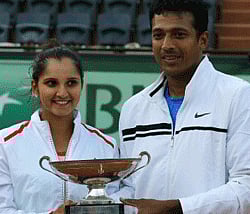 India's Sania Mirza, left, and Mahesh Bhupathi hold their cup after defeating Poland's Klaudia Jans-Ignacik and Mexico's Santiago Gonzalez in their mixed double final match the French Open tennis tournament at the Roland Garros stadium in Paris, Thursday, June 7, 2012. The Indian pair won 7-6, 6-1. AP