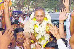 Party workers celebrate the victory of Capt Ganesh Karnik soon after the results were declared in Mysore. DH photo