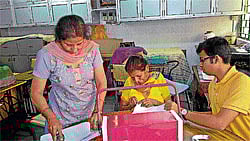 creativity n concern Deaf women being taught to bind used sheets into notebooks by students under project Akshar.
