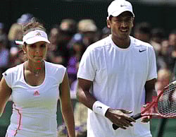 India's Sania Mirza (L) with India's Mahesh Bhupathi during their second round mixed doubles match against Australia's Paul Hanley and Russia's Alla Kudryavtseva on day six of the 2012 Wimbledon Championships tennis tournament at the All England Tennis Club in Wimbledon, southwest London, on June 30, 2012. AFP