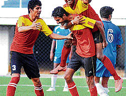 JUBILANT Postals Sharath (centre) celebrates with team-mates Chethan Kumar (left) and Gopi after scoring against KSP during their Super Division tie. DH PHOTO