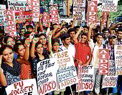 Unhappy: Members of All India Democratic Students Organisation raise slogans, opposing introduction of National Curriculum Framework for I PU science course at Mysore Bank Circle on Saturday. dh photo