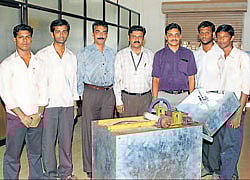 Mechanical Engineering students of Vivekananda College of Engineering (Puttur) display the areca sheaths cutting machine invented by the team. The guides too are seen.