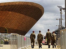 Soldiers walk past the Velodrome at the London 2012 Olympic Park in Stratford, east London July 13, 2012. Credit: Reuters