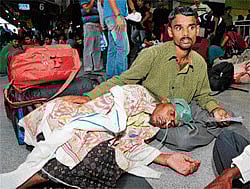 Sick with fear: A tumour patient waits for a North-East bound train at the City Railway Station on Sunday. DH Photo