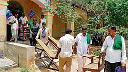 SELF HELP? Activists of Samata Sainik Dal and Raitha Sene shift the furniture of the Bangalore University PG centre to the new building at Mangasandra on the outskirts Kolar on Thursday. DH Photo