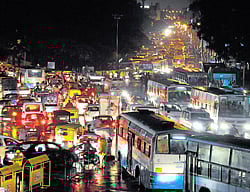 choke point: Traffic crawled on the water-logged road at Town Hall Circle on Saturday.  DH&#8200;Photo/Govindraj Javali