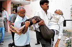 Folklore scholar Prof D Lingaiah being taken to hospital after he suffered a massive cardiac arrest at B M Sri memorial awards ceremony on Wednesday. DH Photo