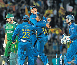 Sri Lankas Rangana Herath (second from right) celebrates with Mahela Jayawardene as Tillakaratne Dilshan and Kumar Sangakkara join in after the fall of Pakistans Shahid Afridi in Colombo on Thursday. AP