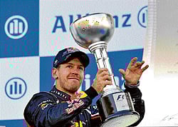 on top again: Red Bull Racings Sebastian Vettel celebrates after winning the Japanese Grand Prix at Suzuka on Sunday. AFP