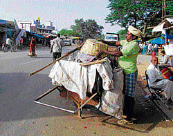 Clean deal: Sanitation workers hired by the Chikkatirupati Gram Panchayat in Malur taluk clean the streets. dh photos