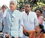 Pointing fingers: Union Law Minister Salman Khurshid gestures angrily at a media person during a press conference in New Delhi on Sunday as his wife, Louise, restrains him. PTI