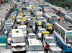 predicament An ambulance caught in a traffic jam on Sheshadri Road.  DH Photo by Savitha B R