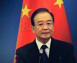 China's Premier Wen Jiabao stands in front of a Chinese national flag. Reuters