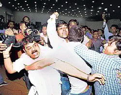 A man is about to throw a shoe at Arvind Kejriwal during a press conference called by members of India Against Corruption in New Delhi on Wednesday. pti
