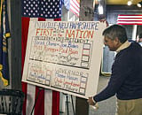 A town clerk makes final adjustments to the voting station on November 5, 2012 in Dixville Notch, New hampshire, where the first voting in the 2012 US presidential election begins at midnight on November 6, 2012. AFP