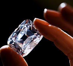 An employee poses with the Archduke Joseph diamond during an auction preview at Christie's in Geneva November 8, 2012. The 76 carat diamond is expected to fetch between 15 million and 20 million US dollars as it auctions in Geneva on November 13. REUTERS