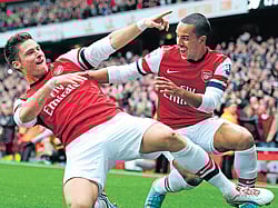 ONTARGET: Arsenal's Olivier Giroud (left) celebrates with team-mate Theo Walcott after scoring against Tottenham Hotspur in the English Premier League on Saturday. AFP