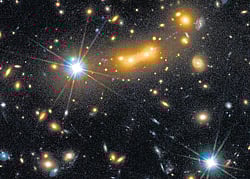 This European Space Agency (ESA) picture shows a view from the Hubble Space Telescope of the massive galaxy cluster MACS J0647.7+7015. AFP