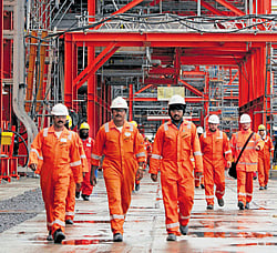 Workers walk at D Island, the main processing hub for the Kashagan oil project, in the northern Caspian Sea. Kashagan field in Kazakhstan, the worlds largest oilfield discovery in four decades - which could boost its output by about 16 percent within a year.  REUTERS