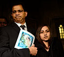 Lisha Barboza stands with her father Ben while he holds a picture of his wife, nurse Jacintha Saldanha, as they leave the Houses of Parliament in London December 10, 2012. Two Australian radio announcers who made a prank call to a British hospital treating Prince William's pregnant wife Kate broke a three-day silence on Monday to speak of their distress at the apparent suicide of the nurse who took their call. REUTERS photo