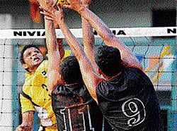 keen tussle LICs Avinash Shetty (left) attempts to smash past Sunil MS (centre) and CK Swamy (right) of ASC during their KVL match in Bangalore on Thursday. DH photo