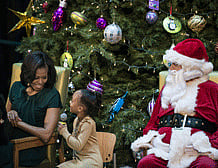 Jordyn Akuoko (C) asks US first lady Michelle Obama a question at Children's National Medical Center December 14, 2012 in Washington, DC. Obama visited the hospital to tour the facility before visiting with patients and staff to read a book and take questions. AFP PHOTO