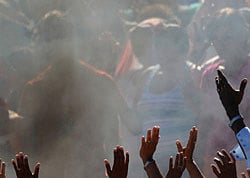 In this Dec. 6, 2012 file photo, people raise their hands during a ceremony by Mayan sages in Bacuranao, Cuba. From Russia to California, thousands are preparing for the fateful day, when many believe a 5,125-year cycle known as the Long Count in the Mayan calendar supposedly comes to an end. In Mexico's Mayan heartland, nobody is preparing for the end of the world; instead, they're bracing for a tsunami of spiritual visitors. Jose Manrique Esquivel, a descendent of the Maya, said his community in Mexico's Yucatan peninsula sees the date as a celebration of their survival despite centuries of genocide and oppression. He blamed profiteers looking to scam the gullible for stoking doomsday fears. AP