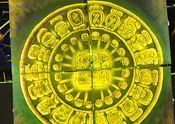 Performers hold up boards to form the symbol for 'Baktun 13' take part in a ceremony to celebrate the end of one Mayan cycle and the start of a new one, in Copan Ruinas, 400 kms northeast of Tegucigalpa, early on December 22, 2012. A global day of lighthearted doom-themed celebration and superstitious scare-mongering culminated on December 21 at the temples of the Mayan people, whose calendar sparked fears of apocalypse. December 21 marked the end of an era that lasted 5,200 years, according to the Mayan 'Long Count' calendar. AFP PHOTO