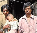 Vijay Diwate, wife Manjula and theirfive-month-old baby Premthey hope to sell to repay growing family debts. DH PHOTO