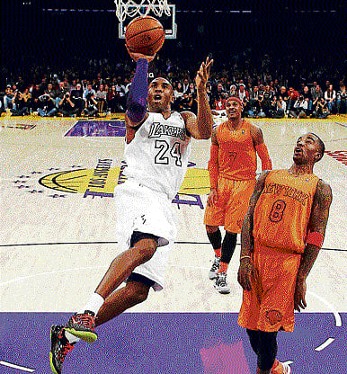 Air borne: Kobe Bryant of LA Lakers goes up to score during their Christmas Day match against New York Knicks. reuters