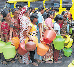 A daily ritual: Women and children lining up to collect water from tankers has become a common sight in a majority of areas in Bangalore. DH Photo
