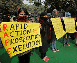 Girls hold play cards during the Aam Admi Party protest to demand justice for the rape victims and Fast Track Courts, at Jantar Mantar in New Delhi on Saturday. PTI Photo
