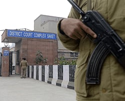 Indian police personnel stand guard at an entrance to Saket District Court in New Delhi on January 7, 2013. Five men charged with the brutal gang-rape and murder of a student in New Delhi will appear in court for the first time after police said they had forensic evidence to link them to the killing. AFP PHOTO
