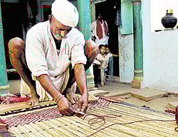 Functional An artisan, engrossed in weaving a charpoy. Photos by author