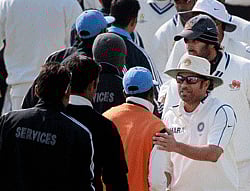 Mumbai's Sachin Tendulkar and other players exchange greetings with Services players after the end of their Ranji Trophy semi-final match at Palam in New Delhi on Monday. PTI Photo