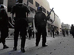Unrelenting protests: Riot police take up positions during clashes with protesters opposing Egyptian President Mohamed Morsi along Simon Bolivar Square, which leads to Tahrir Square, in Cairo on Wednesday. reuters