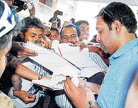 Impressed: V V S Laxman signing autographs.
