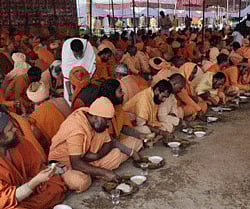Sadhus take part in a Bhandara during Maha Kumbh Mela in Allahabad. PTI Photo