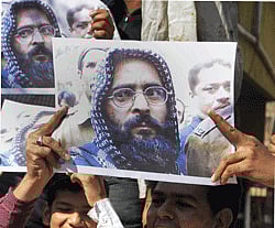 People celebrate the hanging of Afzal Guru, Jaish-e-Mohammad militant convicted in attack on Parliament in 2001, at a rally in Ahmedabad on Saturday. PTI Photo