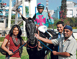 One for the album: Owners Mrs MM Annaiah (left), N Ramesh (extreme right) and trainer Tharun Thimmaiah (second from right) lead in Drop Of Honey (S John astride) after the victory in the Stayers Trial Stakes at the Bangalore Turf Club on Saturday. DH PHOTO