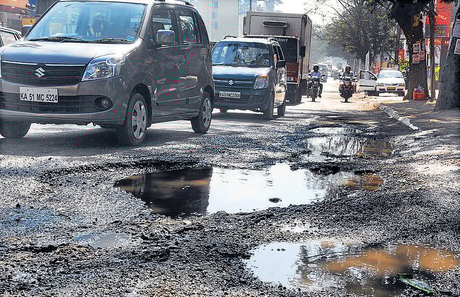 Inconvenient Huge: potholes in front of Forum Auto House on Hosur Road.