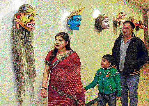 Heritage (Left)Visitors look at traditional bamboo masks displayed at ICCR. (Right) Mask of Bali.