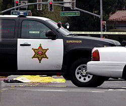 A man, believed to be the shooter, lies dead in the street near an Orange County Sheriff's vehicle in Villa Park, California, February 19, 2013. A gunman on a shooting spree in suburban southern California shot and killed three people and wounded two others on Tuesday before killing himself, police said. REUTERS
